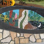 Mosaic landscape scene with carpet snake, galah, pelican and wattle flowers
