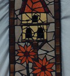 bmosaic birdhouse with flowers and a pigeon sitting atop