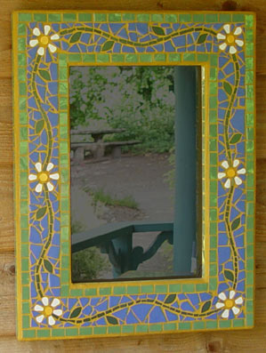 Daisys with a blue and green background on a mosaic mirror