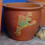 mosaic of a tree frog crawling on the side of a terracotta pot