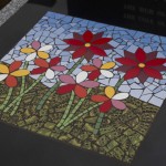 colourful flowers depicted in mosaic against a blue sky