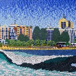 Mosaic Beach scene from Mooloolaba with a wave and buildings in background