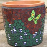 violets and butterfly on a pot in ceramic mosaic