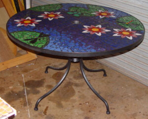 large mosaic table with waterlilies and lily pads and dragonfly