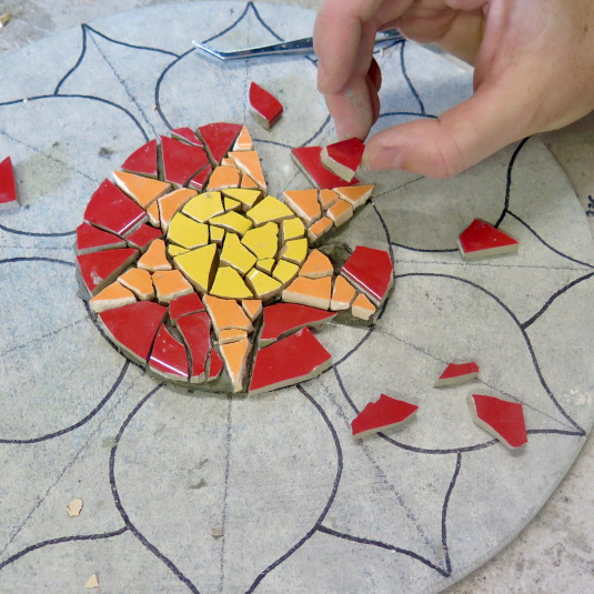 laying a piece into a mindfulness mosaic kit